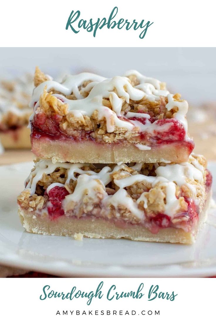 two pieces of raspberry crumb bars stacked on top of each other with white icing