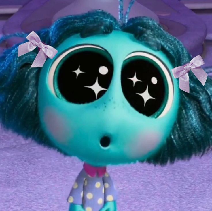 a close up of a doll with big eyes and blue hair, wearing polka dots