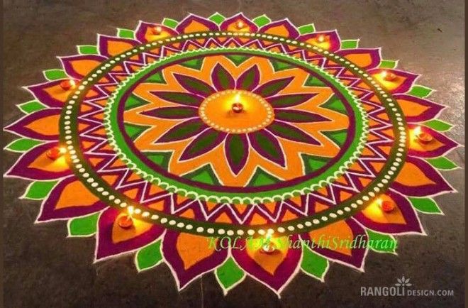 a colorful rangdi design with candles on the ground