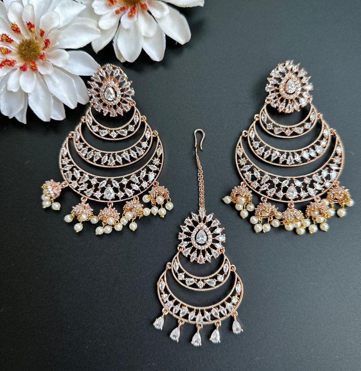 This Set comes with Maangtikka and matching earrings and in 3 beautiful pastel colors. Extremely high quality stones and handwork for a beautiful elegant look. This lightweight and elegant Maangtikka set is perfect for any bridesmaid, bride, sangeet or any occasion or event as a gift for any occasion as any one who loves jewelry will love this statement piece. It has beautiful colors that really make the set a statement piece. Product Details: • Tikka/Headpiece • Earrings Free Shipping/Ready to Luxury Meenakari Tikka For Festive Season, Luxury Multicolor Festive Jhumkas, Wedding Chandbali Jhumkas With Elegant Design, Elegant Wedding Danglers With Stone Work, Elegant Festive Tikka With Matching Earrings, Traditional Rose Gold Jewelry Sets For Festive Occasions, Traditional Rose Gold Jewelry Sets For Festivities, Elegant Chandbali Tikka, Elegant Rose Gold Earrings For Festive Occasions