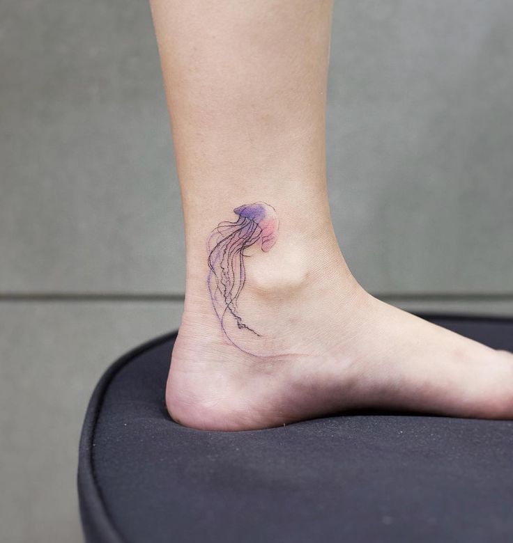 a small jellyfish tattoo on the ankle