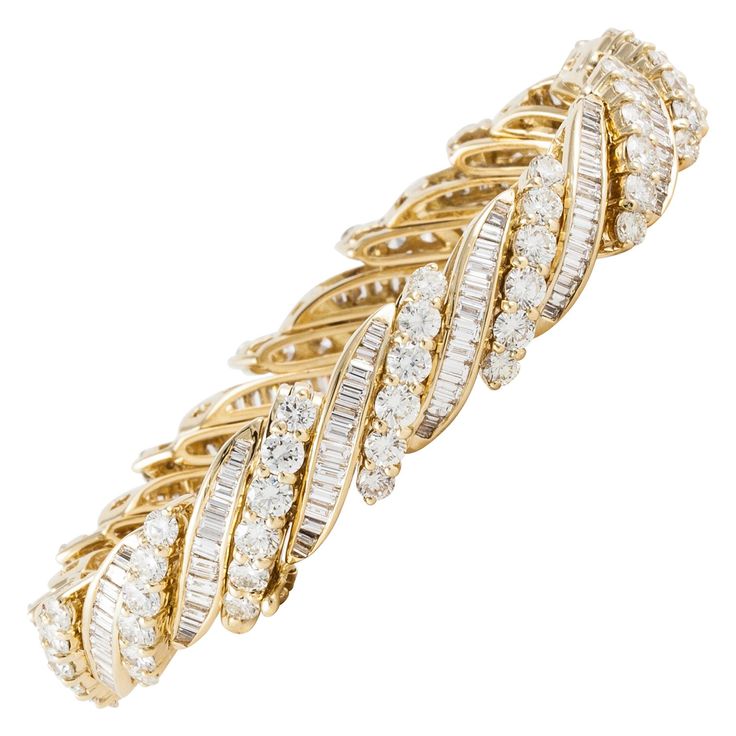 18K yellow gold bracelet featuring both round and baguette diamonds. There are 84 round diamonds totaling 9.8 carats and 196 baguette diamonds totaling 4.2 carats. Total diamond weight is 14 carats; H-I color and VS-SI clarity. Measures 7 inches long and 7/16 inches wide. Closure is hinged with a figure eight safety. Buccellati Bracelet, Round Diamond Bracelet, Blue Sapphire Bracelet, 18k Gold Bracelet, Gold Link Bracelet, White Gold Sapphire, Floral Bracelet, White Gold Set, Baguette Diamonds