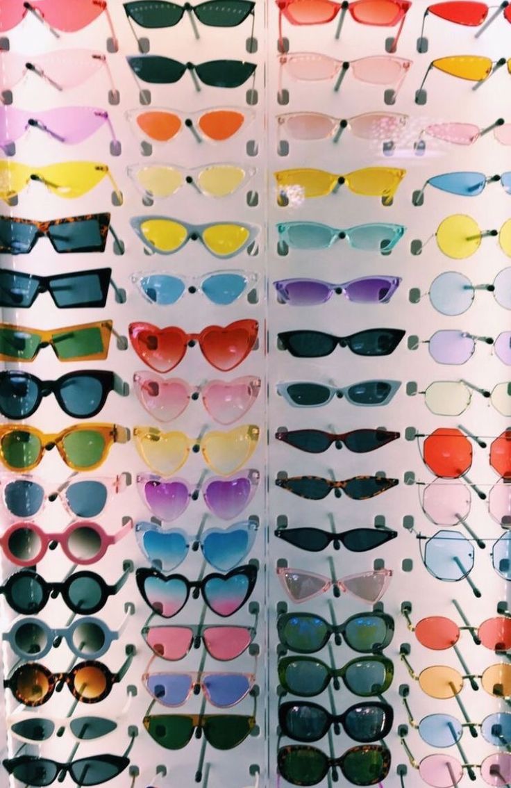 many different colored sunglasses are on display