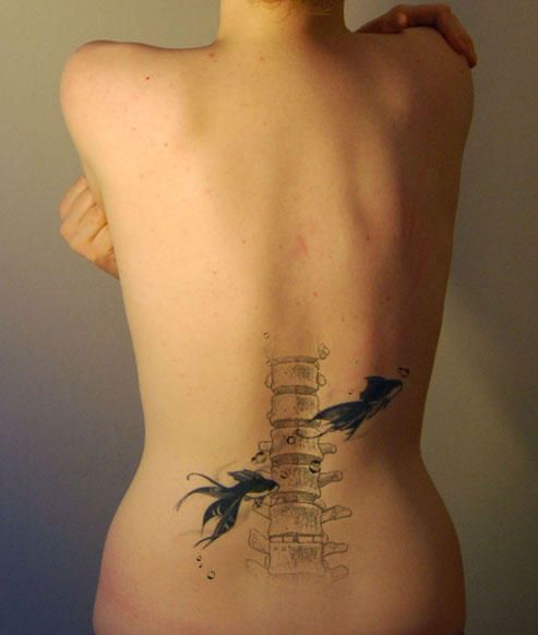 the back of a woman's body with birds on it and books behind her