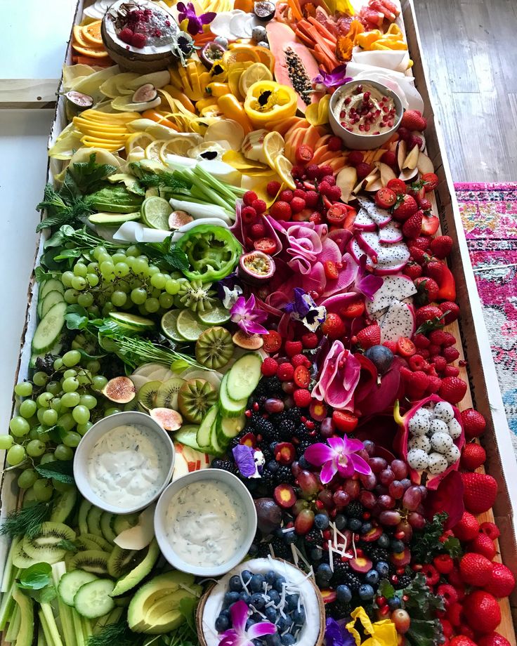 a long table filled with lots of different fruits and veggies on top of each other