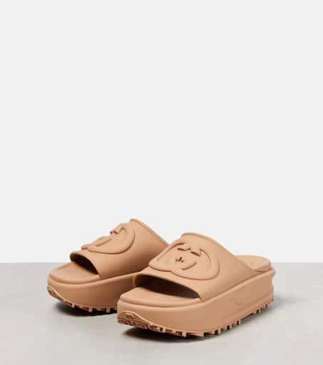 Finish your poolside looks with these platform slides from Gucci. They are made from rubber featuring GG embossing on the straps and are set on chunky rubber soles..Toe shape: round toe.Lining: rubber.Upper: rubber.Comes with dust bags.Comes with a box.Designer color name: Vintage Camel.Sole: rubber insole and sole.Made in Italy.True to size.Half sizes please take the next size down.European sizes.4,5cm-2' platform (size EU 38).5cm-2' wedge heel (size EU 38) Trendy Synthetic Slides With Textured Sole, Casual Slides With Chunky Platform, Synthetic Material, Casual Synthetic Slides With Chunky Platform, Beach Slides With Thick Synthetic Sole, Beach Slides With Thick Synthetic Bottom, Synthetic Beach Slides With Thick Bottom, Gucci Open Toe Slides With Rubber Sole, Gucci Slide Sandals For Summer, Gucci Spring Slides With Round Toe