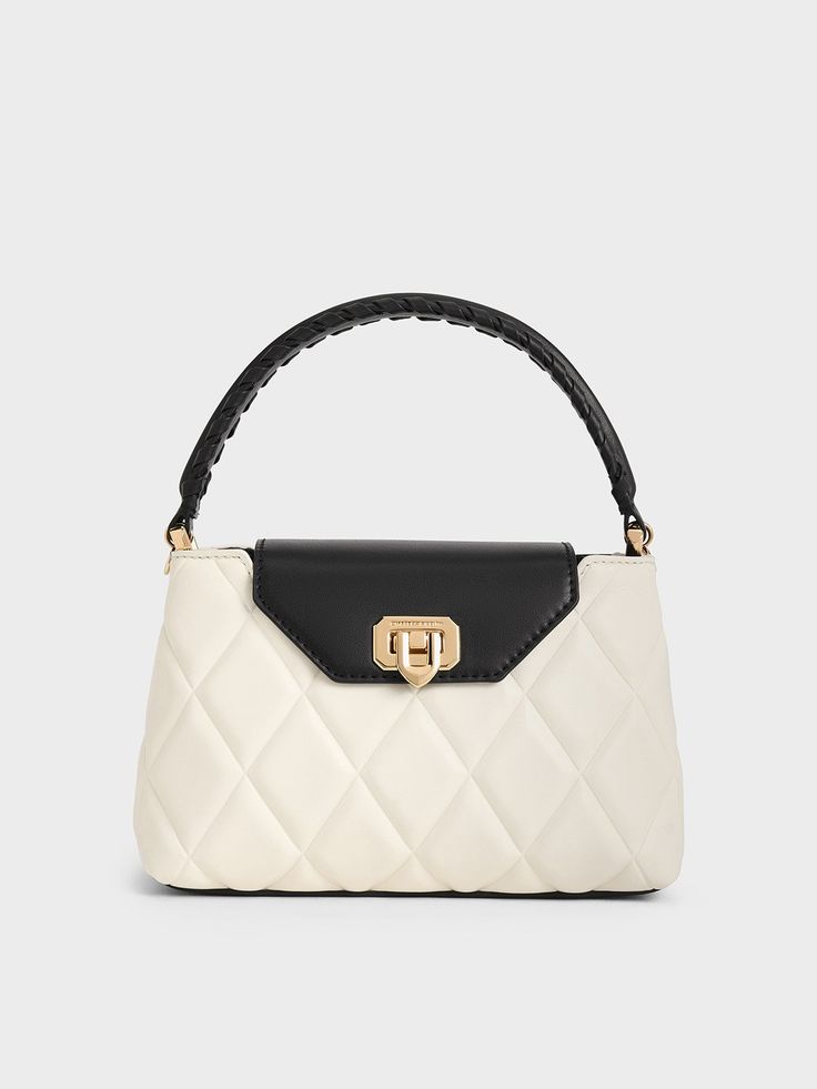 This product is made with at least 20% sustainable materials by weight. CHARLES & KEITH uses recycled, degradable, organic, and water-based materials in our eco-conscious collection. You can never go wrong with a black-and-white combination. This top-handle silhouette features elegant quilting in a striking contrast finish, which will make an impression yet remain versatile enough to be paired with various outfits. As an elevated detail, the braided top-handle adds stylish flair. You can opt ... Charles And Keith Bags, Designer Bags Black, Elegant Bags, Charles Keith, Braided Strap, Strap Tops, Sustainable Materials, Handle Bag, Sling Bag