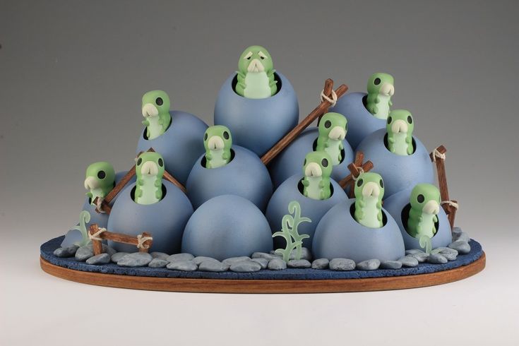 a group of blue and green figurines sitting on top of each other