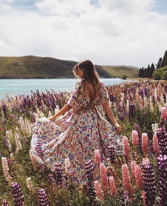 a woman in a field with flowers and the words love yourself so much that when someone treats