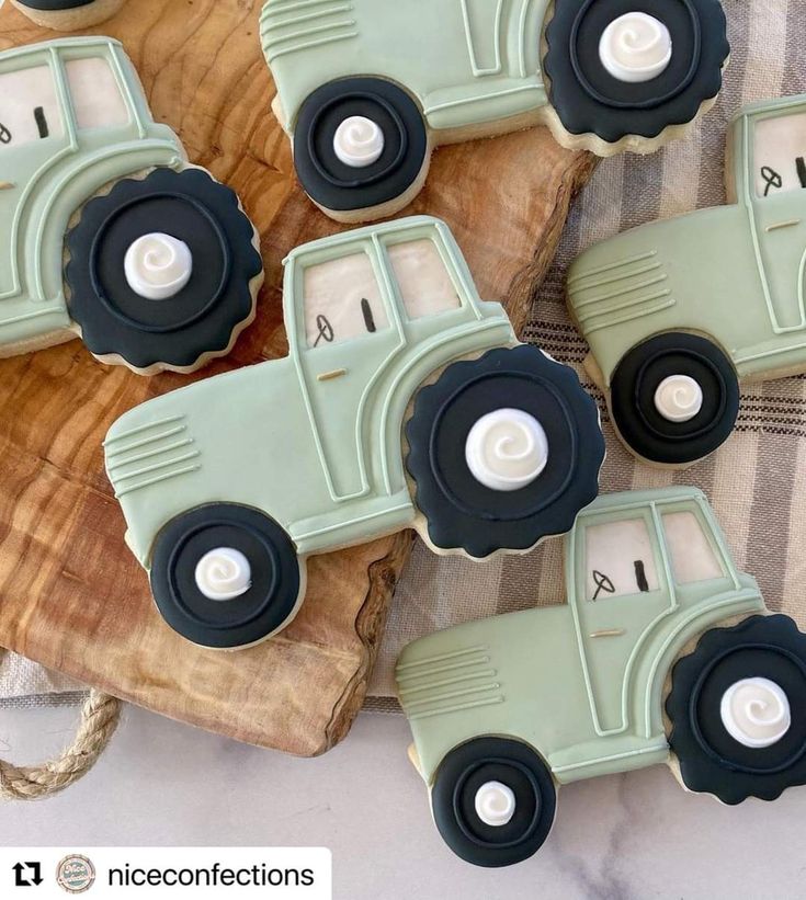 four decorated cookies in the shape of tractors