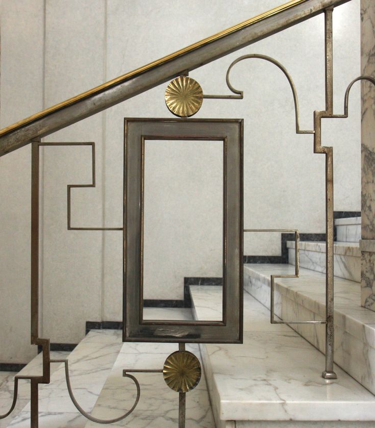 a set of stairs with metal frames and marble steps