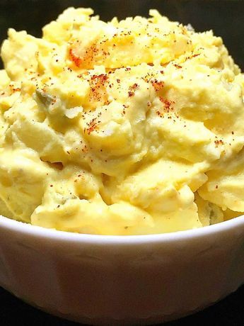 a white bowl filled with mashed potatoes on top of a table