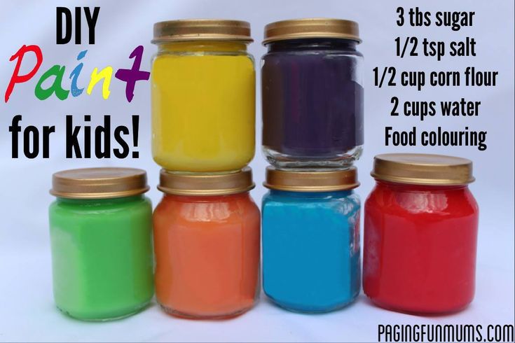 four jars filled with different colored paint sitting next to each other