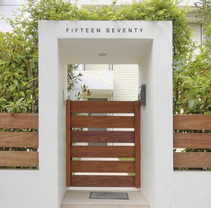 an entrance to a modern home with wooden slats