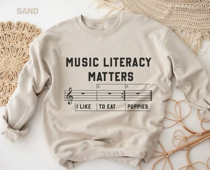 a sweatshirt that says music literracy matters, like to eat puppies