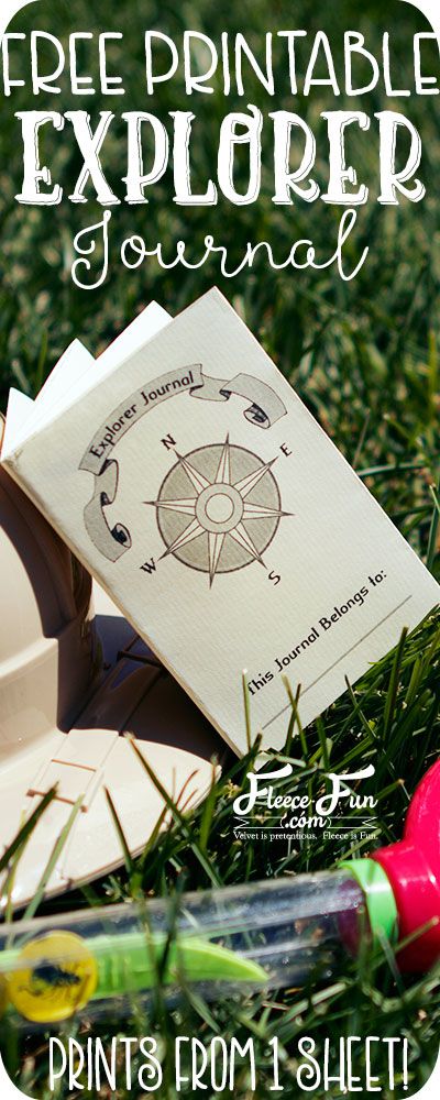 the free printable explorer journal sits in the grass next to some crayons