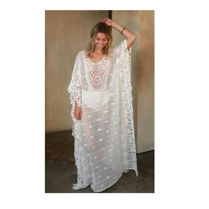 The Romantic Mykonos Kaftan is perfect for your next day by the oceanside. The semi-sheer touch is perfect to throw over a bathing suit. Whether you are spending a day by the pool or elevating this dress with a bag and heels, you will always be looking chic. Semi Sheer One Size Fits All Length measures 53" inches from shoulder to bottom hem 100% Cotton Chic Tunic Cover-up For Beach Season, Airy Flowy Dress For Beach Cover-up, Long Beachwear Swimwear As Beach Cover-up, Bohemian Sheer V-neck Cover-up, Long Flowy Cover-up For Vacation, Flowy Long Cover-up For Vacation, White Sheer Beachwear Cover-up, White Flowy Cover-up For Vacation, White Breezy Cover-up For Poolside