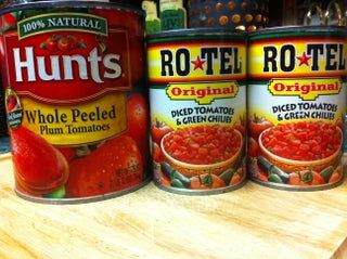 three cans of tomato soup sitting on top of a counter