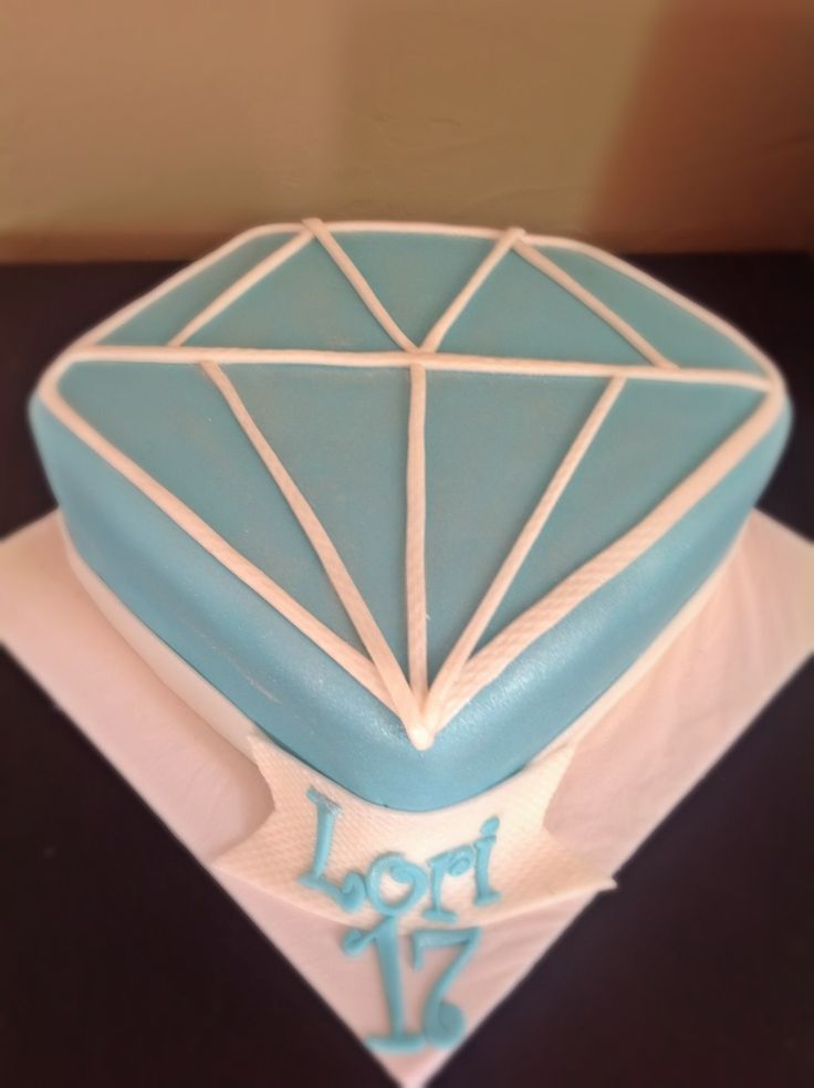 a blue and white diamond shaped cake on top of a napkin with the word joy written in it