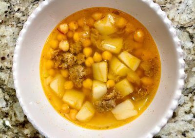 a white bowl filled with food on top of a counter