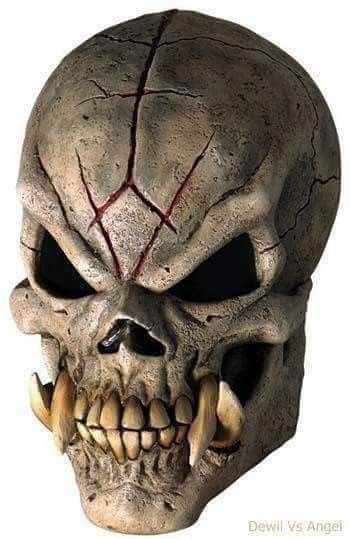 a skull mask with teeth and fangs on it's face is seen in this image