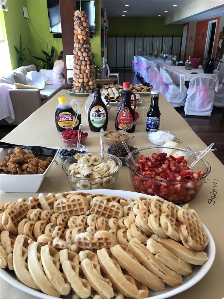 a table topped with waffles and other foods