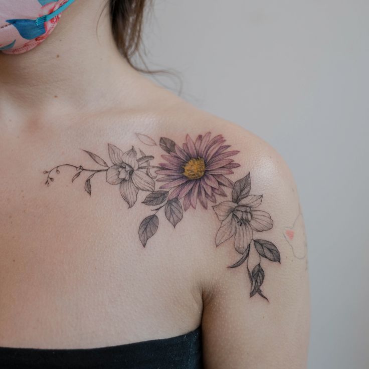 a woman's shoulder with flowers on it