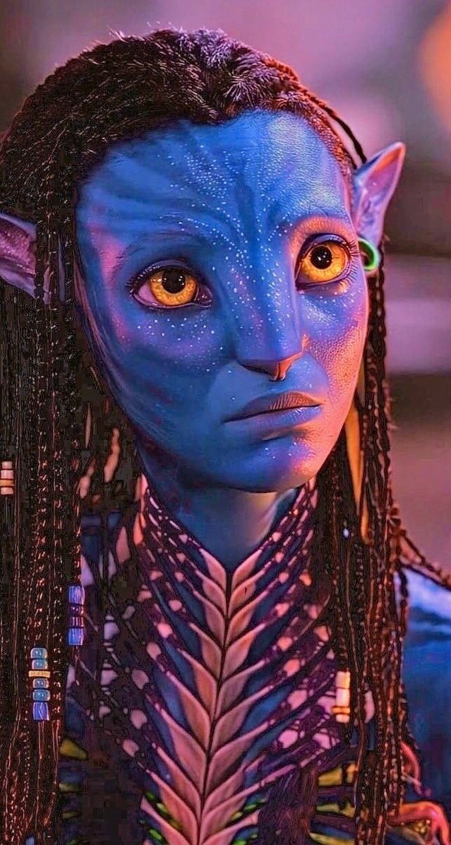 a woman with blue makeup and braids on her head, wearing an alien costume