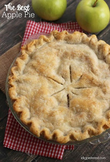 an apple pie sitting on top of a wooden table