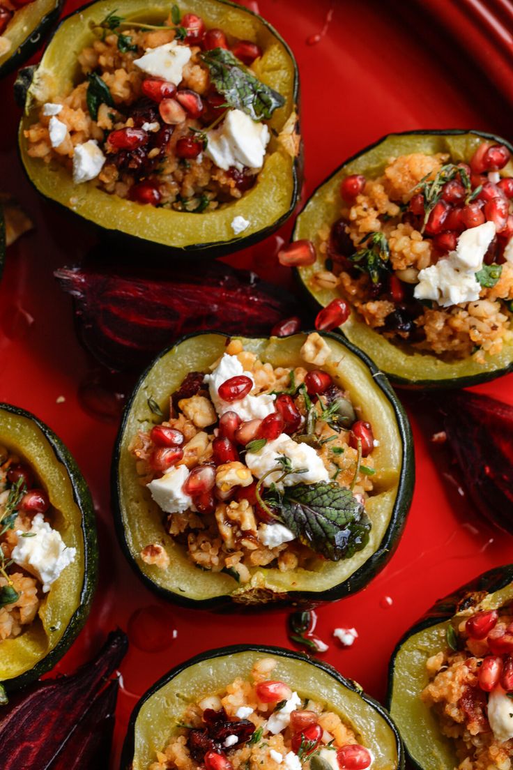 stuffed bell peppers with feta cheese and spinach on a red plate, ready to be eaten