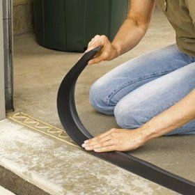 a man sitting on the ground with a hose in his hand