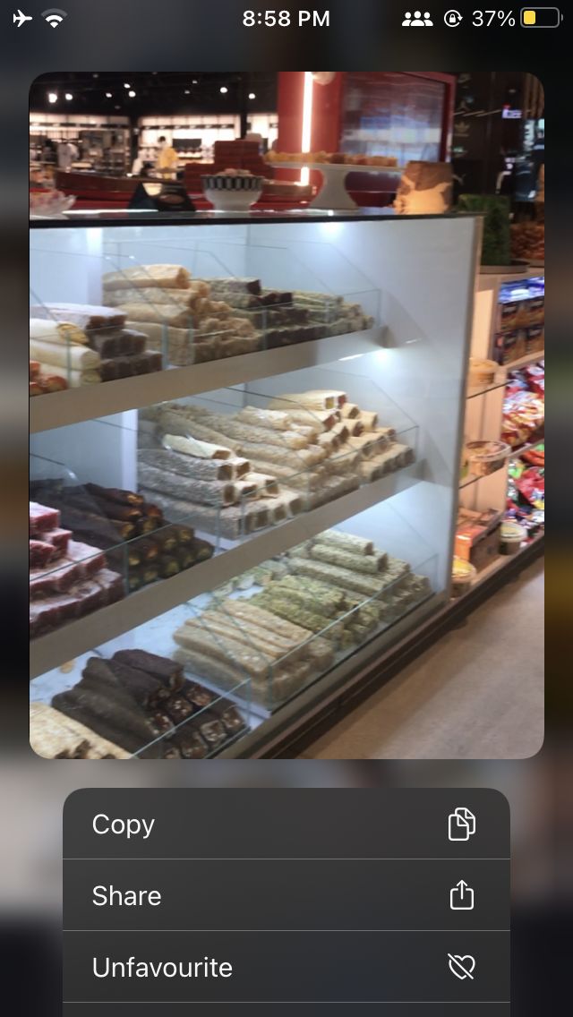 an image of a bakery display case full of pastries