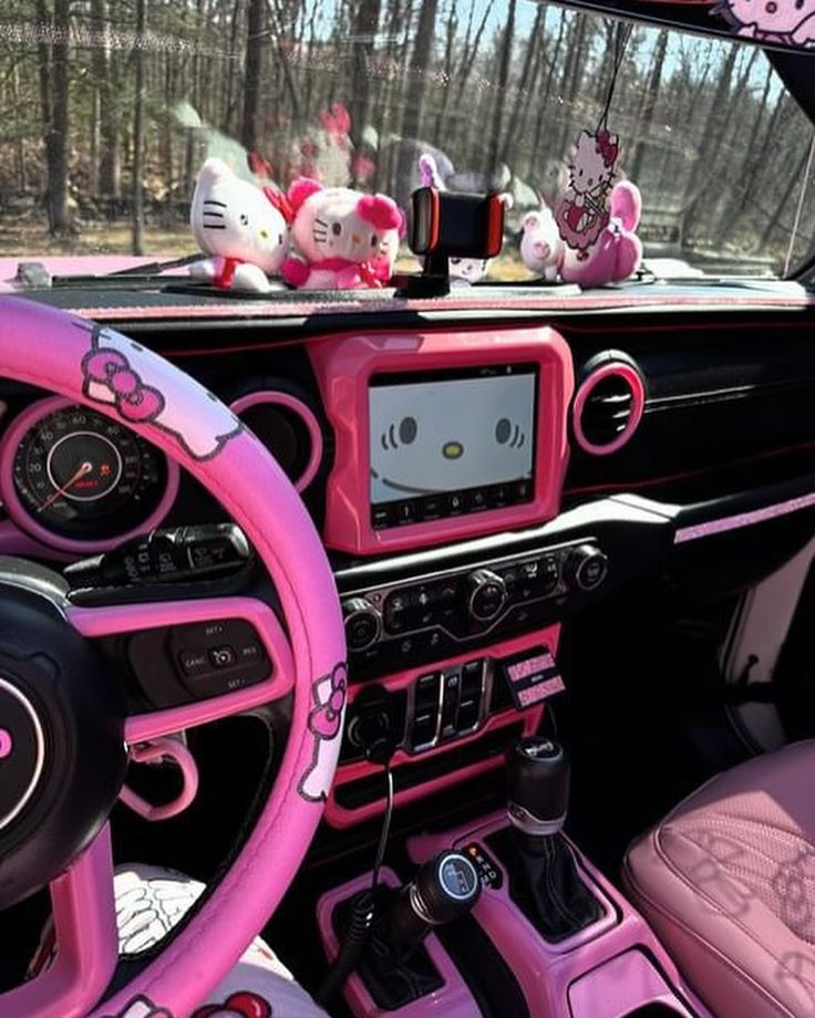 the interior of a car with hello kitty decorations on the dash board and steering wheel