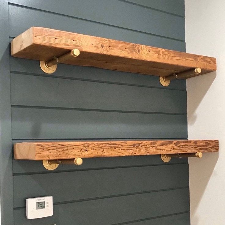 two wooden shelves on the side of a wall