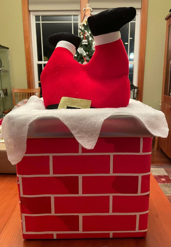 a santa clause shoe sitting on top of a brick box