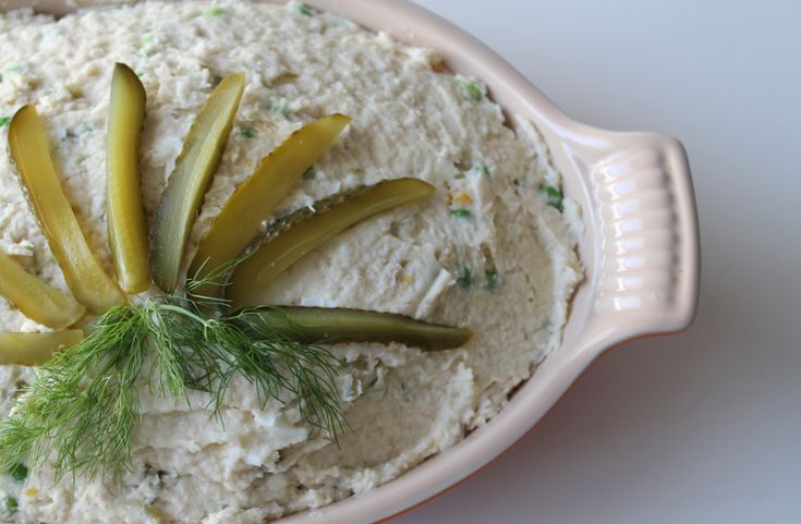 a bowl filled with food and garnished with dill sprigs on top