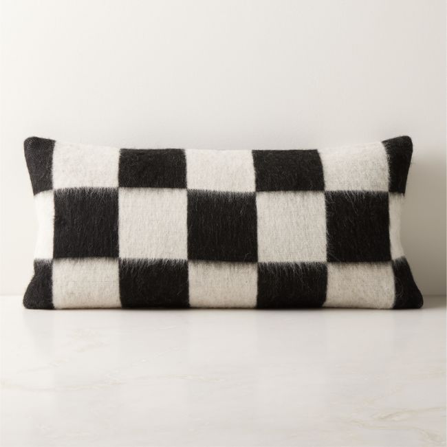 a black and white checkered pillow sitting on top of a table