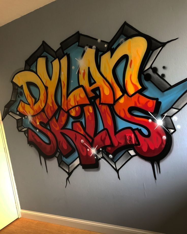 a wall with some graffiti on it in a room that is painted gray and orange