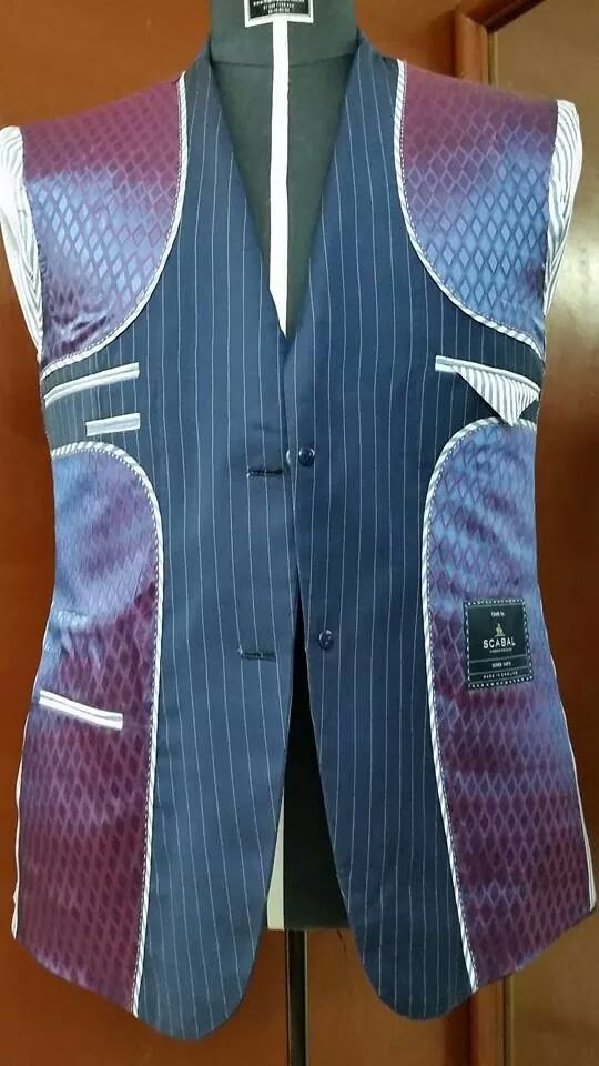 a blue vest with purple and white pinstripe on the front, along with a black shirt underneath