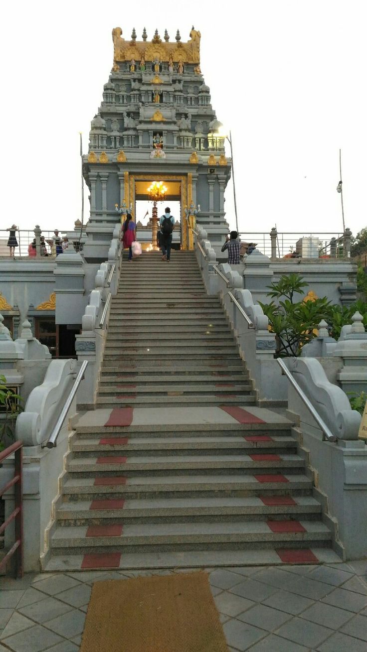 the stairs lead up to an elaborately decorated temple