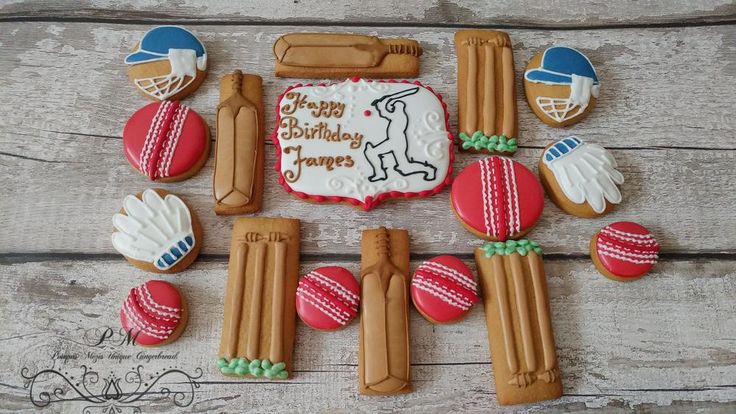 decorated cookies are arranged in the shape of baseball bats, bat and ball on a wooden table