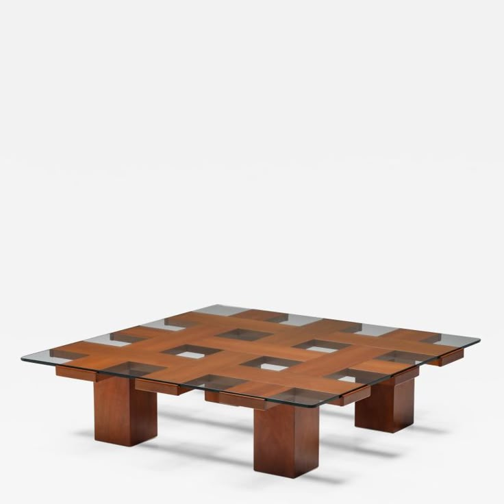 a glass and wood coffee table with squares on the top, against a white background