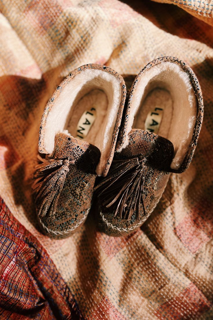 **THIS ITEM IS ON PRE-ORDER ESTM SHIPPING OCT 15TH Our genuine Suede Snake Moccasin with large hand tied tassel, adds a bit of eclectic luxury to your day. Lined in super soft genuine shearling, this fun shoe is cozy too. Style them folded down like a moccasin, or up like a bootie. This year our genuine shearling mocs have a new and improved fit to be more comfortable than ever! We also added an outdoor sole so we can all take these babies to the streets! You know you have been walking the dog i Eclectic Luxury, New And Improved, Outdoor Wear, Shoe Game, Dog Walking, Shoe Box, Nice Shoes, Moccasins, Bootie