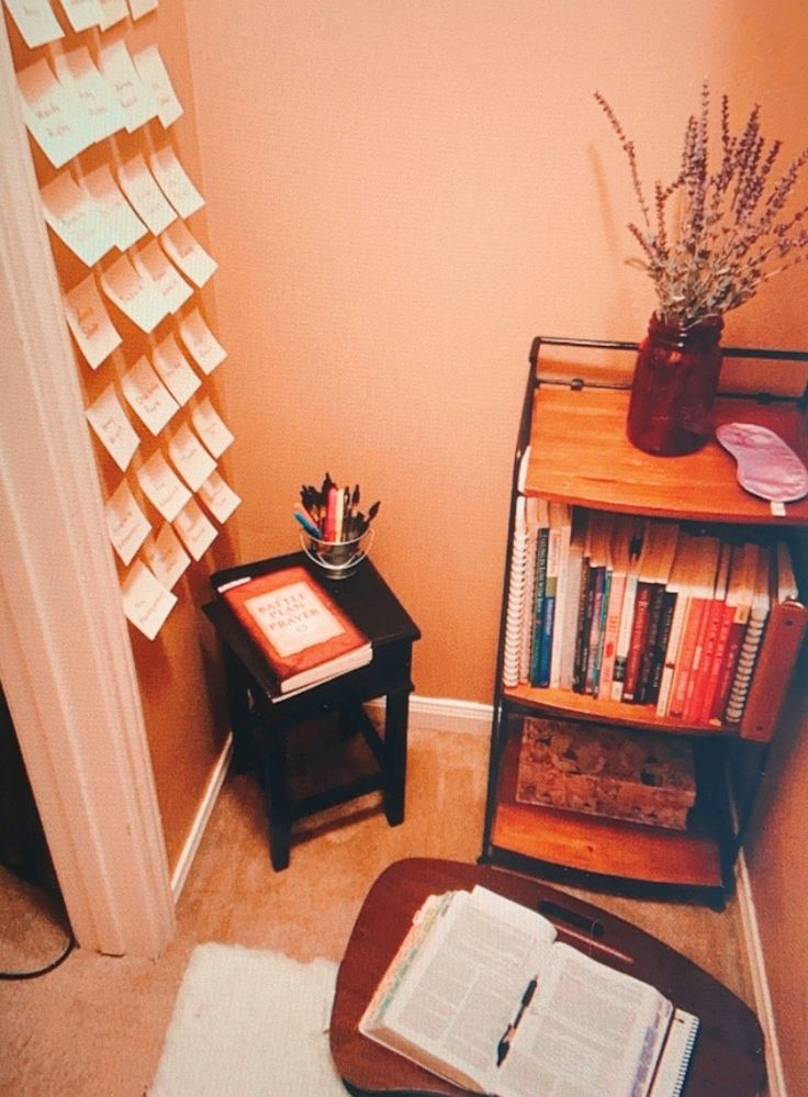 an open book on a table next to a bookshelf