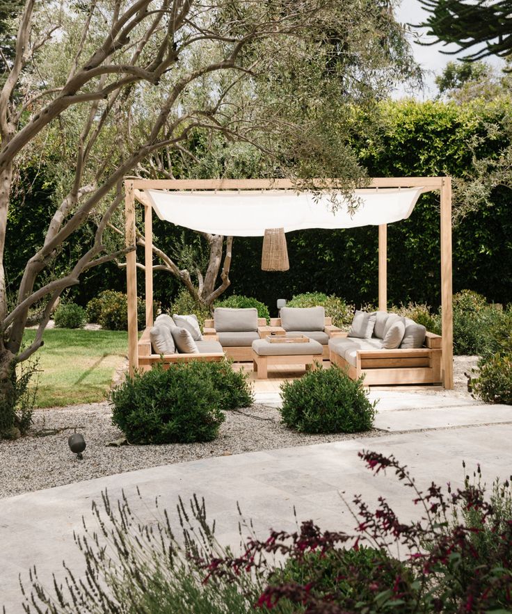 an outdoor living area with couches and trees