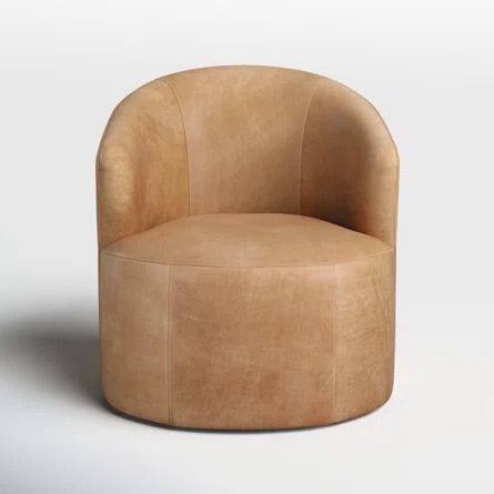 a tan leather chair on a white surface with no one in it's seat