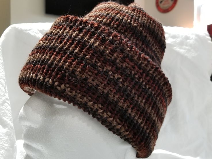 Warm double-layer stretchy knit hat in variegated shades of brown and copper. 100% acrylic yarn is machine washable and dry flat. Sized for most adults or older teens, the hat is reversible if need be and brim can be folded double for a closer beanie-style fit or folded smaller for a slouchy fit. Great unisex color and perfect for upcoming cooler weather. Remember, winter is coming! :-) Warm Brown Hat One Size Fits Most, Brown Knitted Hat One Size Fits Most, Warm Brown Hat, One Size Fits Most, Brown Cap For Cold Weather, Brown Beanie Cap One Size Fits Most, Brown Brimmed Hat For Cold Weather, Brown Knitted Beanie One Size Fits Most, Adjustable Brown Beanie For Fall, Casual Brown Hand Knitted Crochet Hat