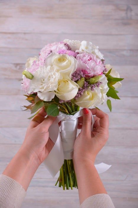 a person holding a bouquet of flowers in their hands