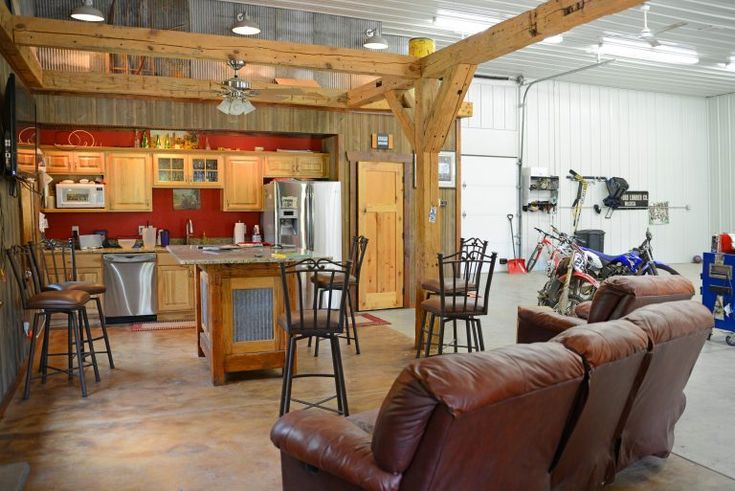 a living room filled with furniture next to a kitchen and dining room table in a garage