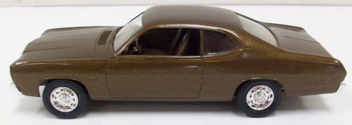 a brown toy car on a white surface